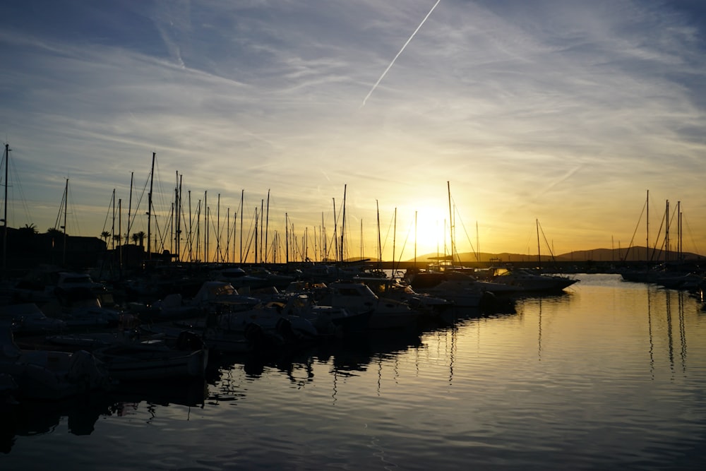 a harbor filled with lots of boats under a cloudy sky