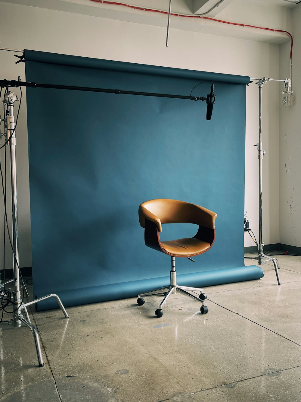 a chair sitting in front of a blue backdrop