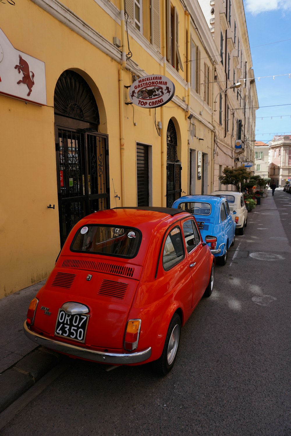 a row of cars parked on the side of a street