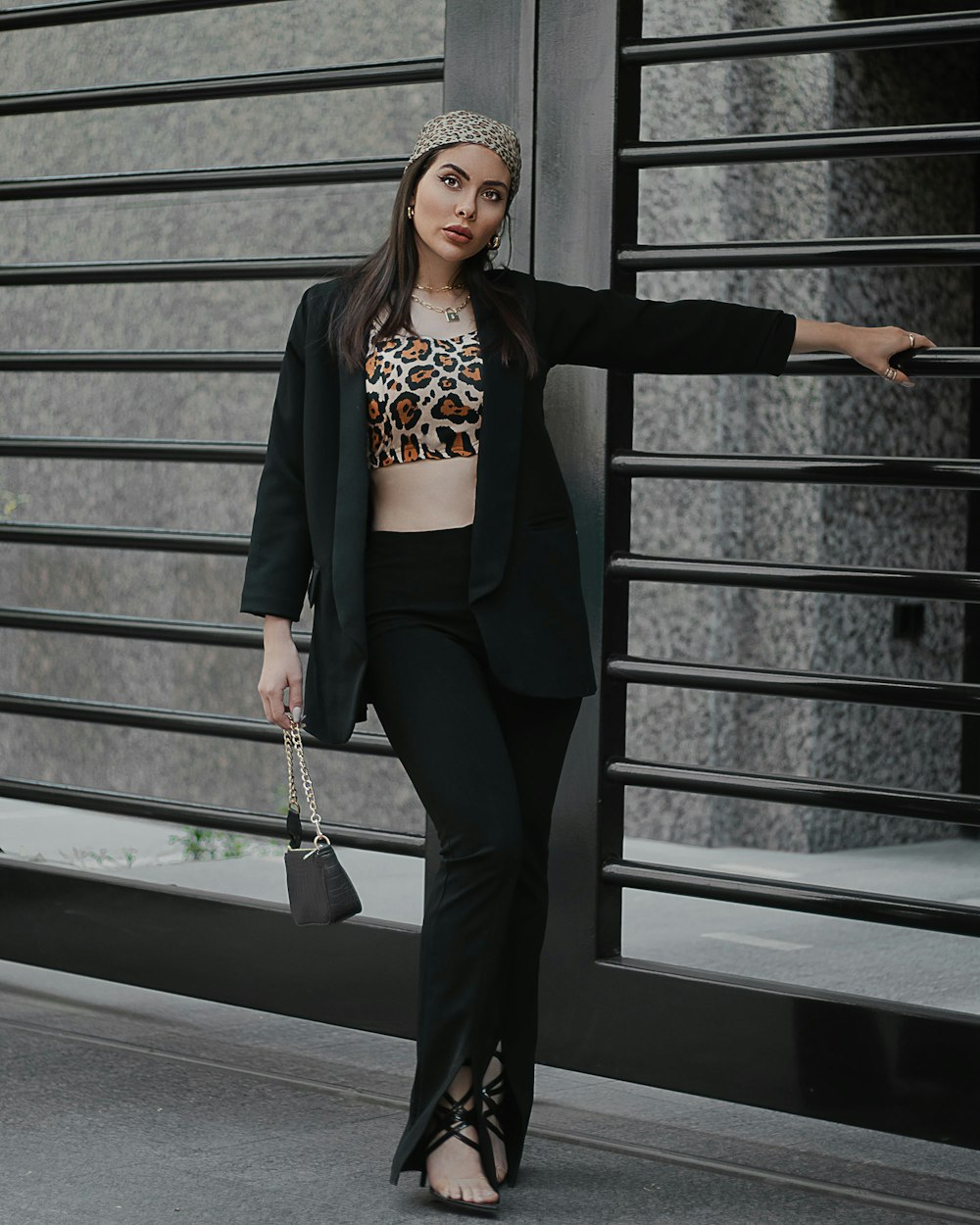a woman in a leopard print top and black pants