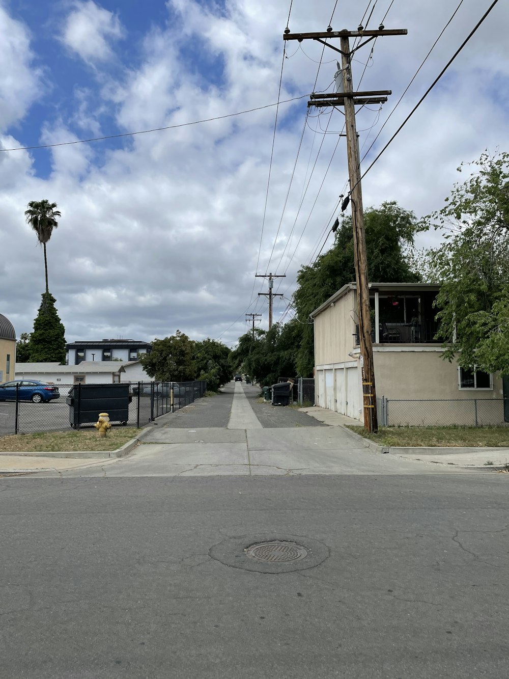 a street with a yellow fire hydrant on the side of it