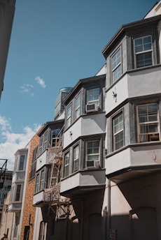 a row of multi - story buildings with a blue sky in the background