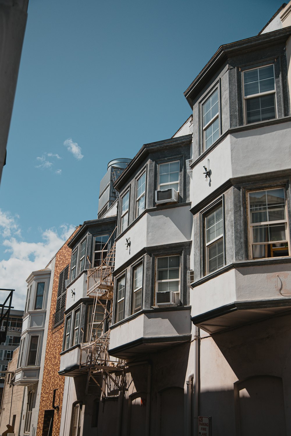 a row of multi - story buildings with a blue sky in the background