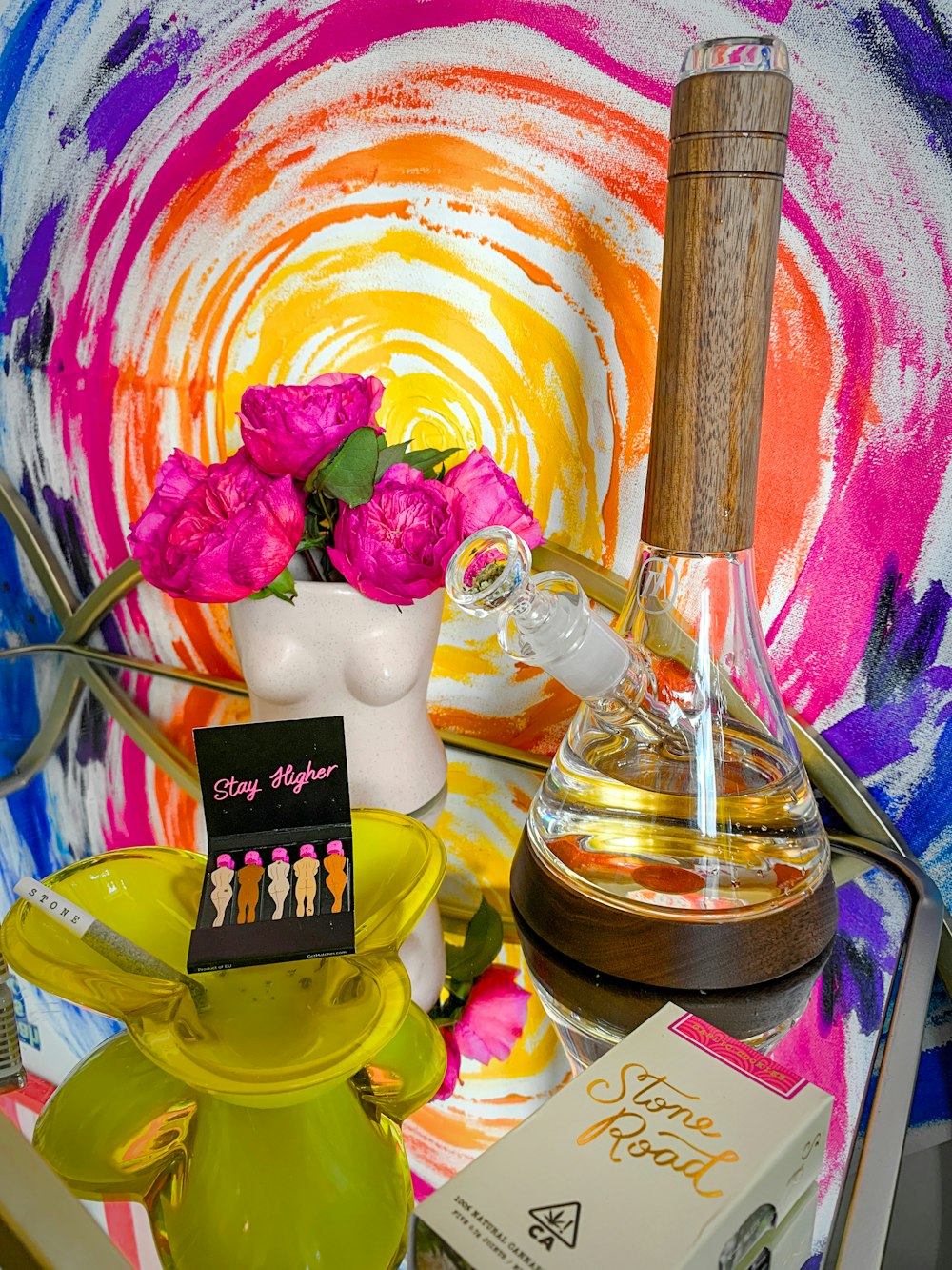 a table topped with a vase filled with flowers