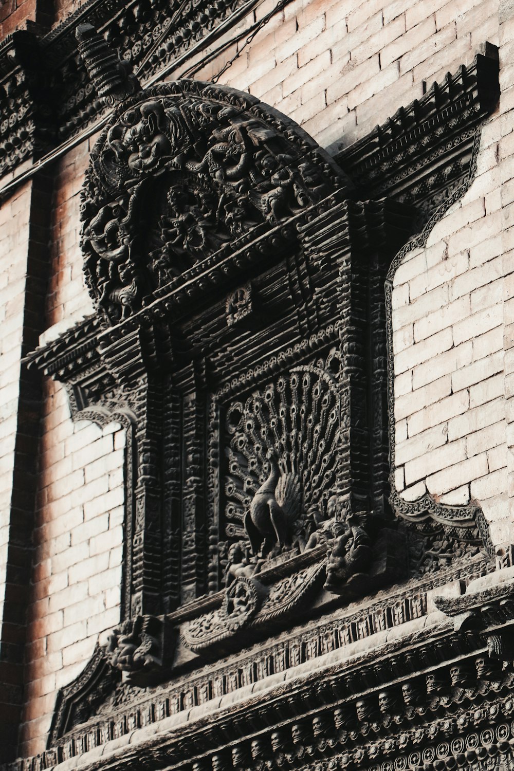 a brick building with a decorative design on it