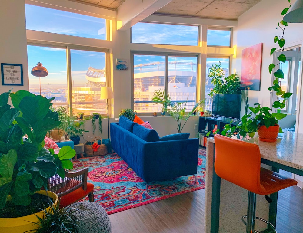 a living room filled with furniture and lots of windows