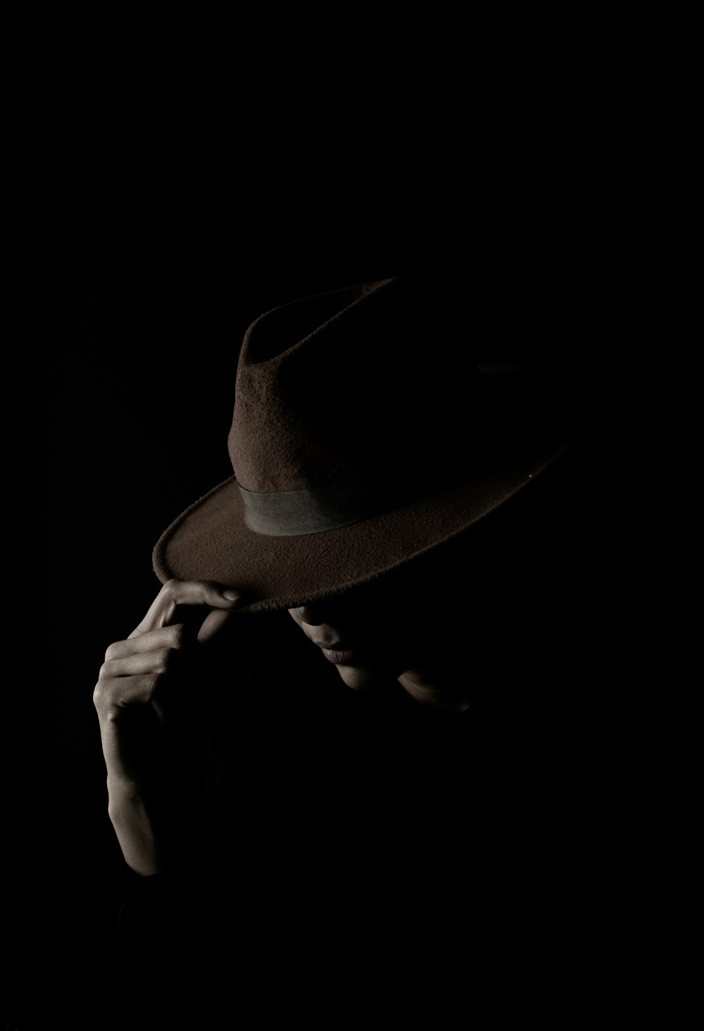 a person wearing a hat in the dark