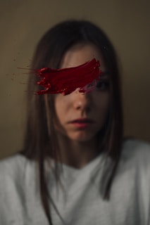 a woman with red paint on her face