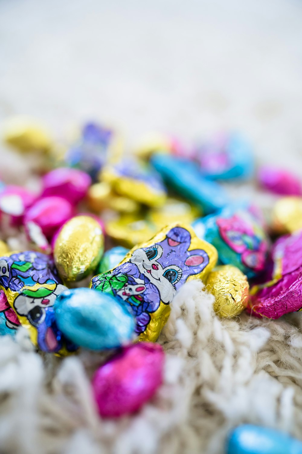 a pile of chocolate eggs sitting on top of a white blanket