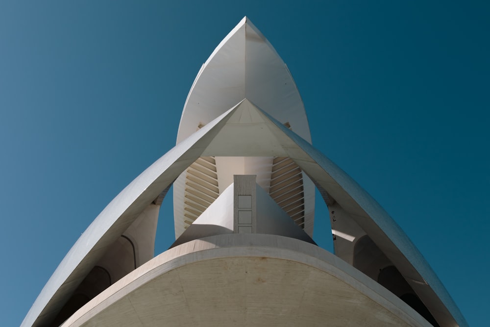 a tall white building with a clock on it's side