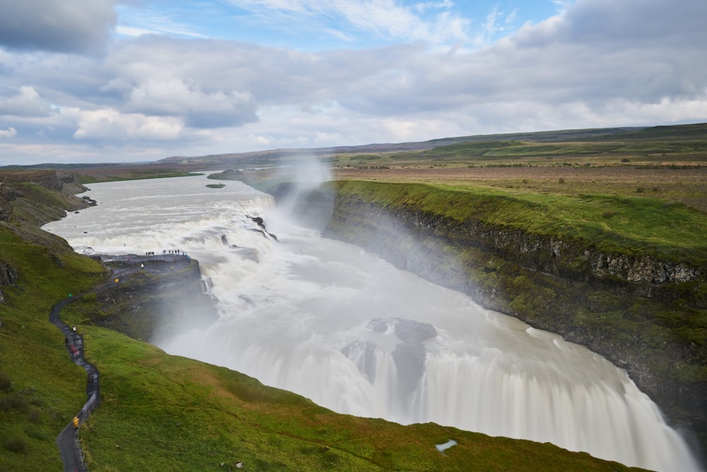 a large waterfall in the middle of a large body of water