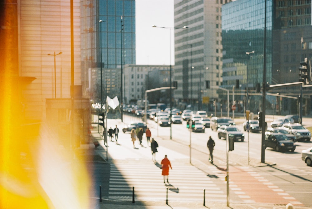 a city street filled with lots of traffic next to tall buildings