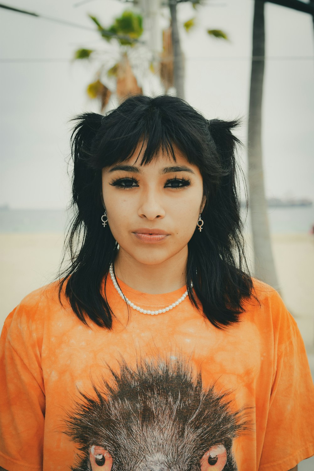 a young woman with a weird hairdo and an emu t - shirt