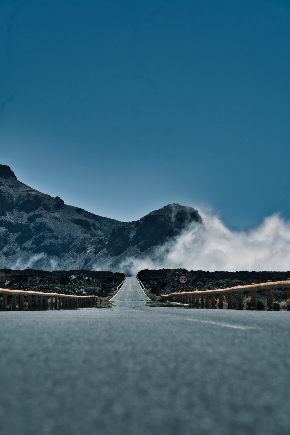 a view of a road with mountains in the background