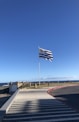 a flag is flying in the wind on a sunny day