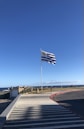 a flag is flying in the wind on a sunny day