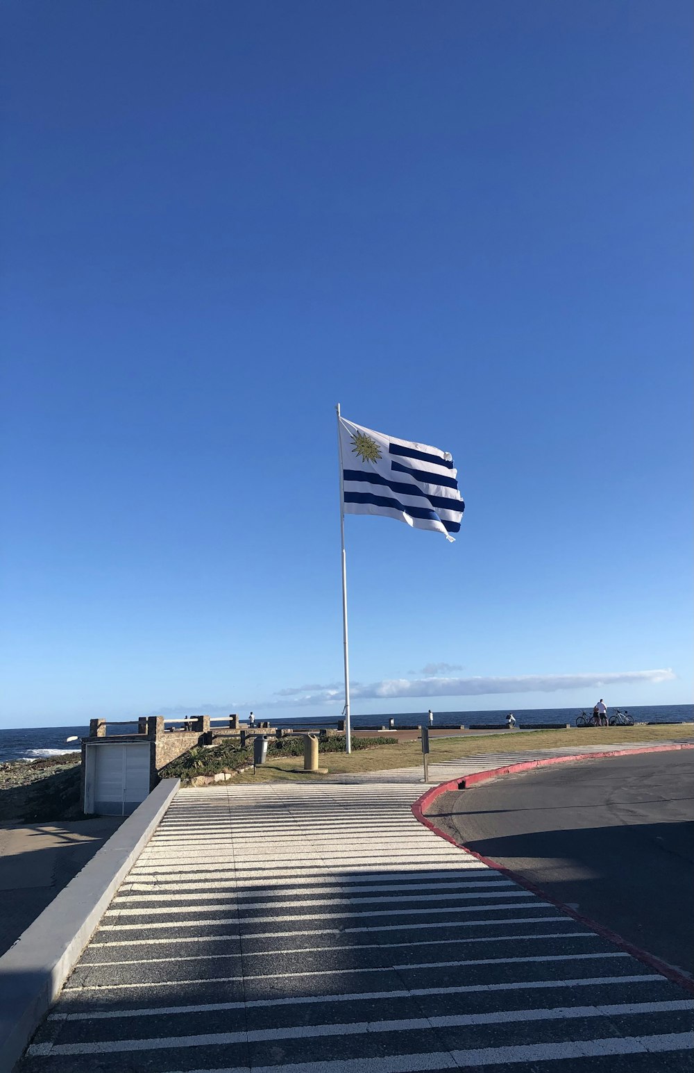 a flag is flying in the wind on a sunny day