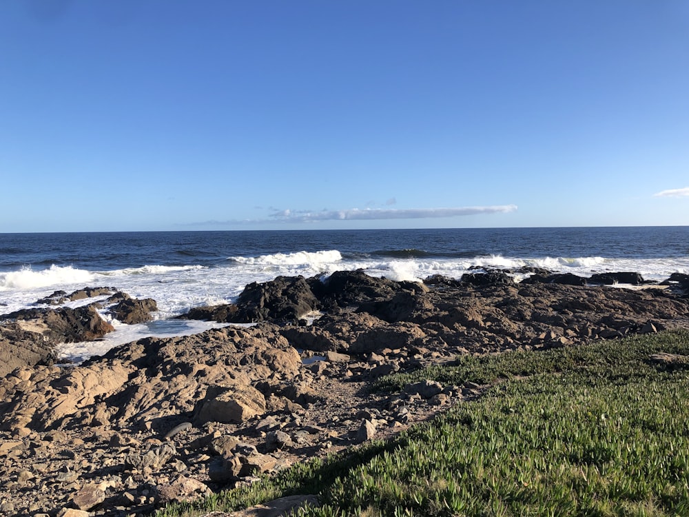 a view of the ocean from a rocky shore