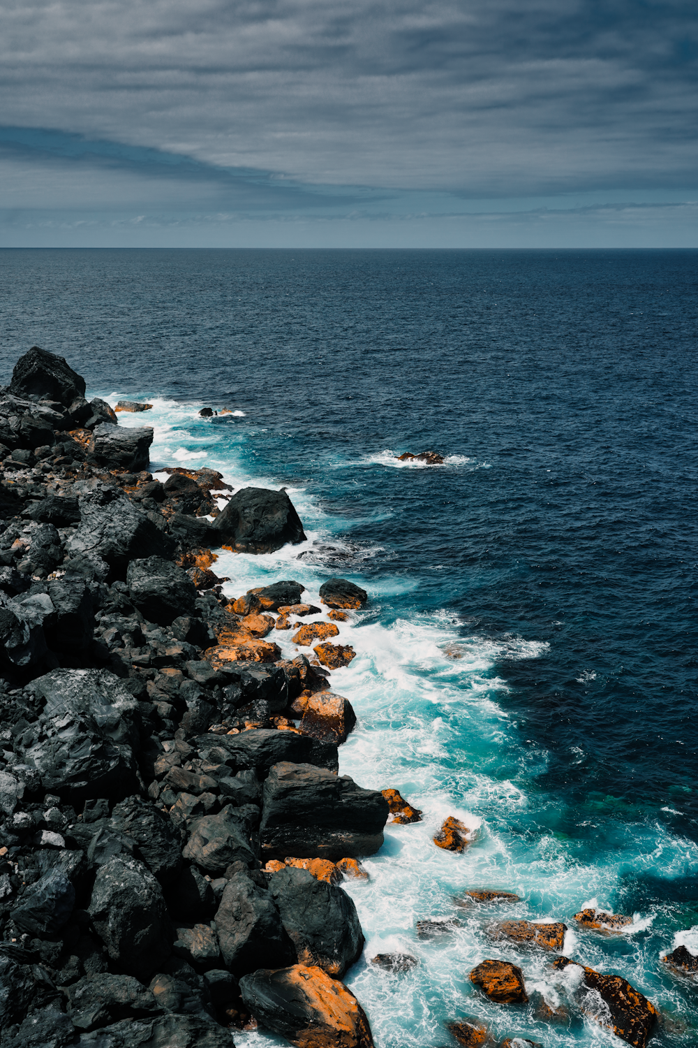 a view of the ocean from a rocky cliff