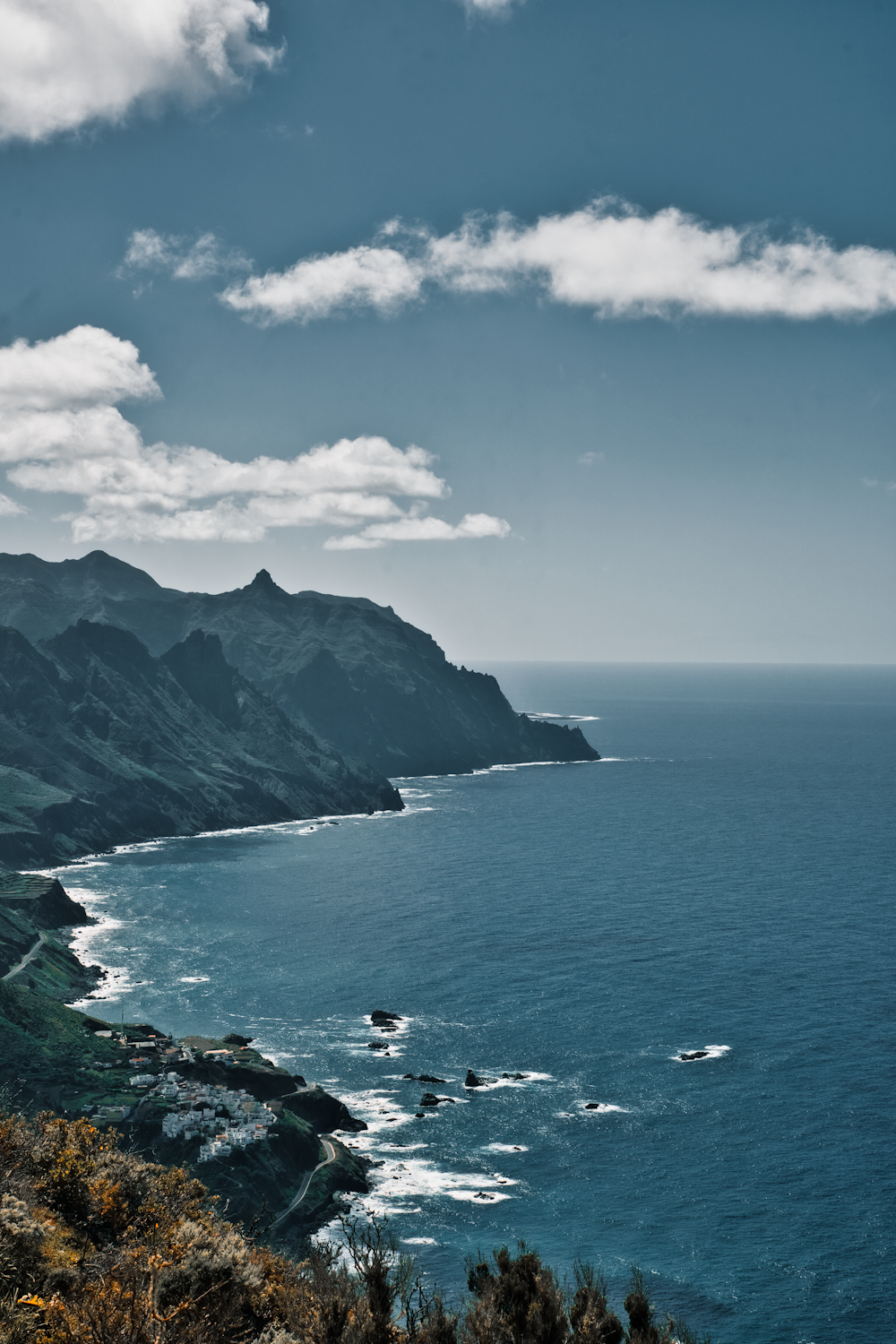 a scenic view of the ocean and mountains