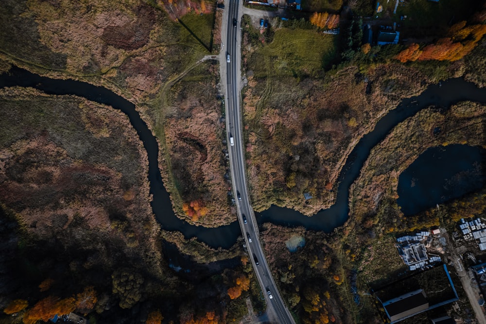 an aerial view of a winding road in autumn