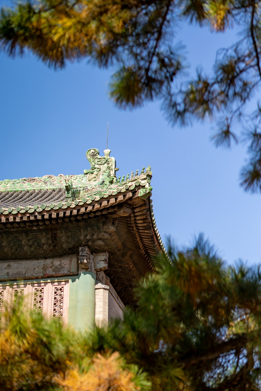 the roof of a building with a statue on top of it