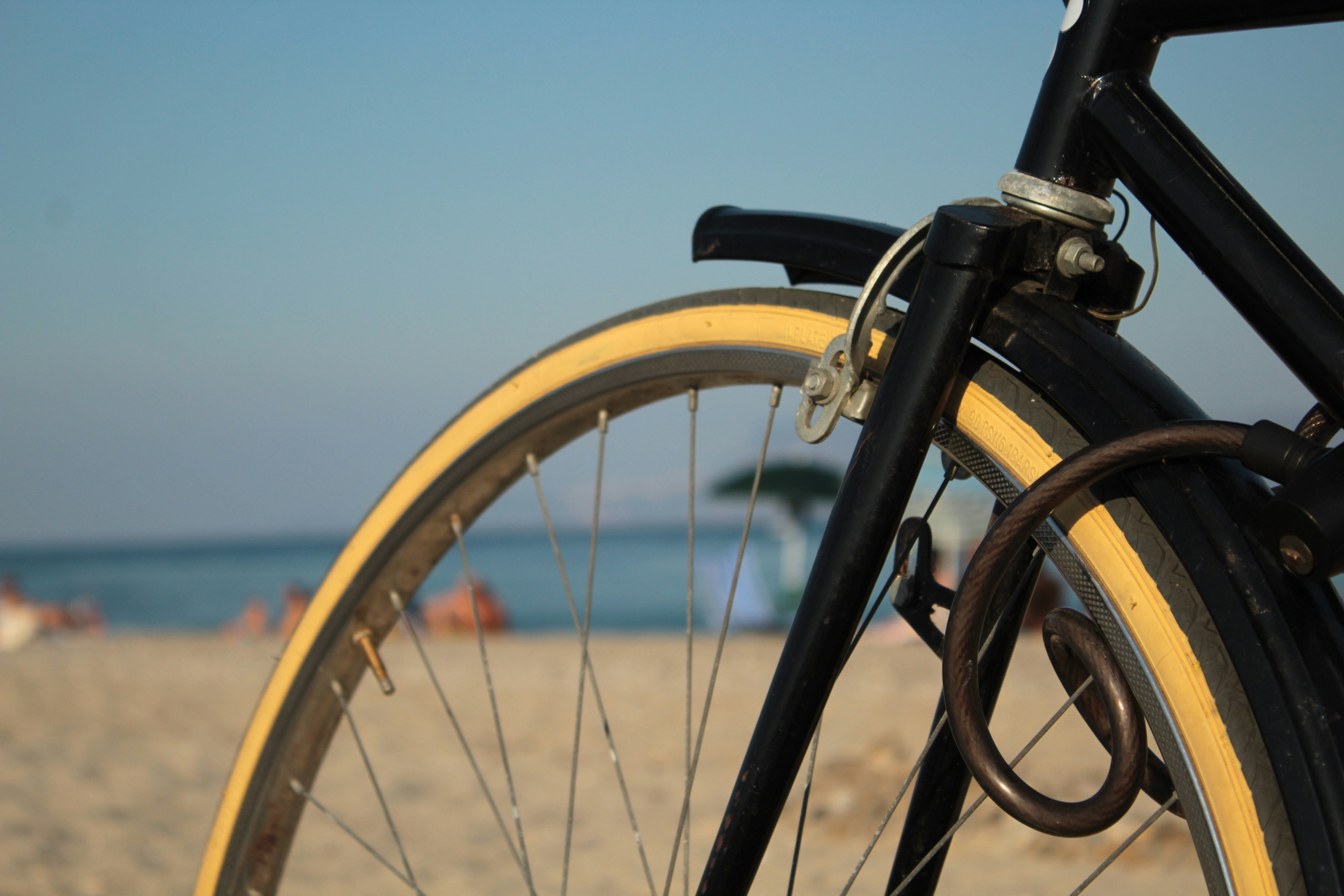a close up of a bike parked on a beach
