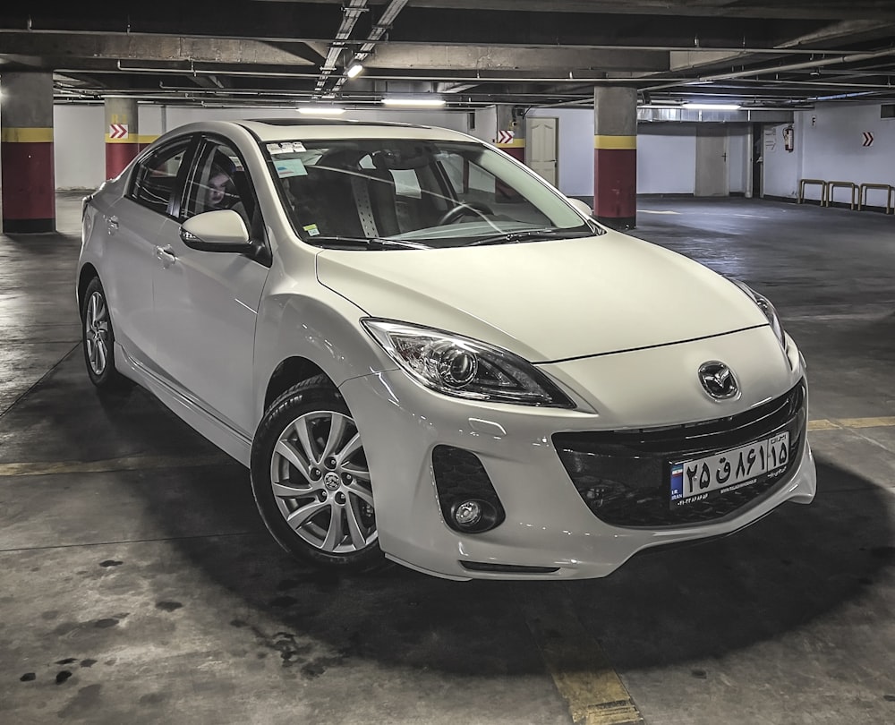 a white car parked in a parking garage