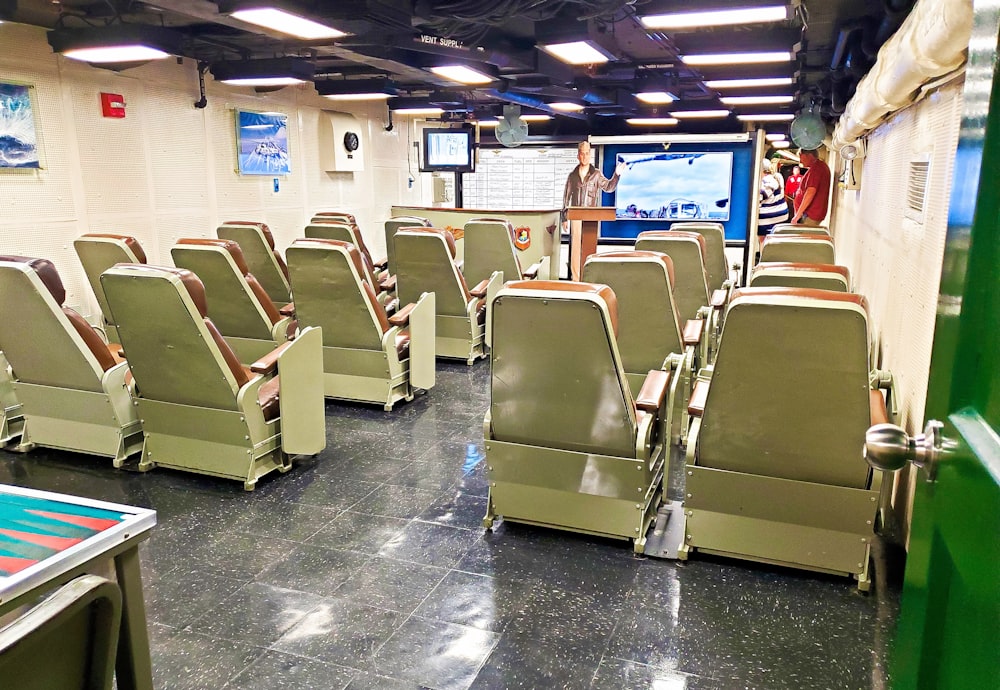 a room filled with lots of green chairs