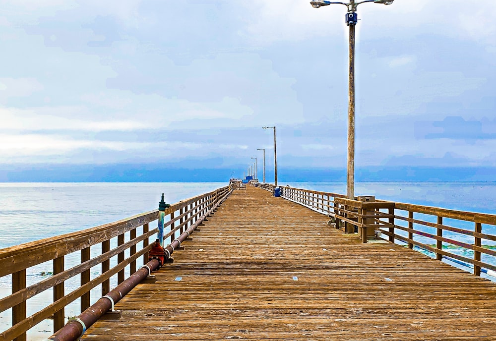 a wooden pier with a street light on top of it