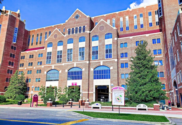 a large brick building with many windows and a sign in front of it