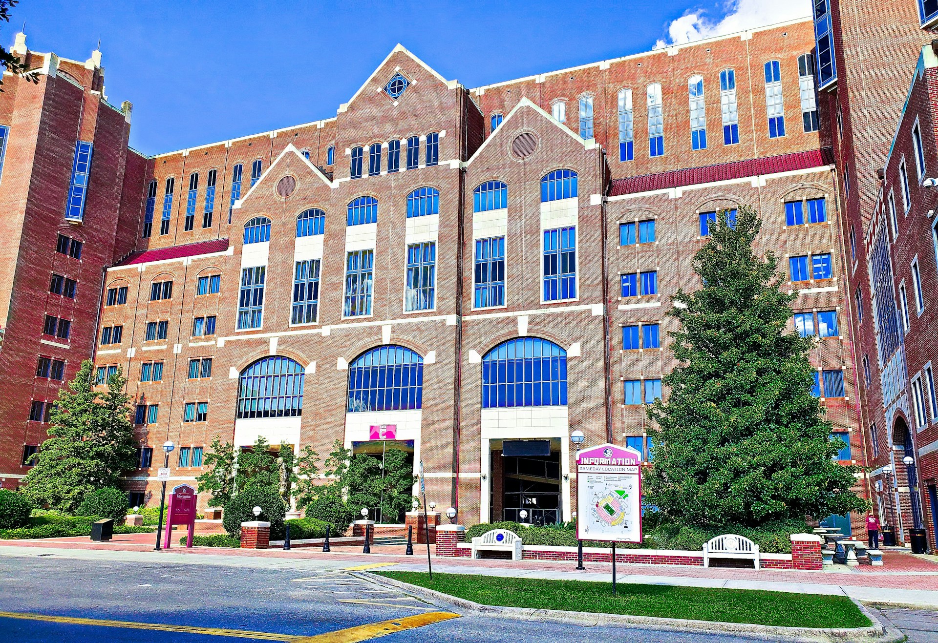a large brick building with many windows and a sign in front of it