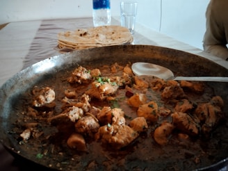 a pan filled with food sitting on top of a table
