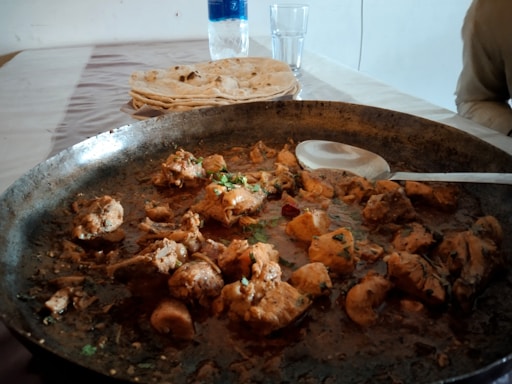 a pan filled with food sitting on top of a table