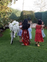 A colorful photo of a group of children playing together in the garden.