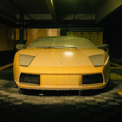 a yellow sports car parked in a parking garage