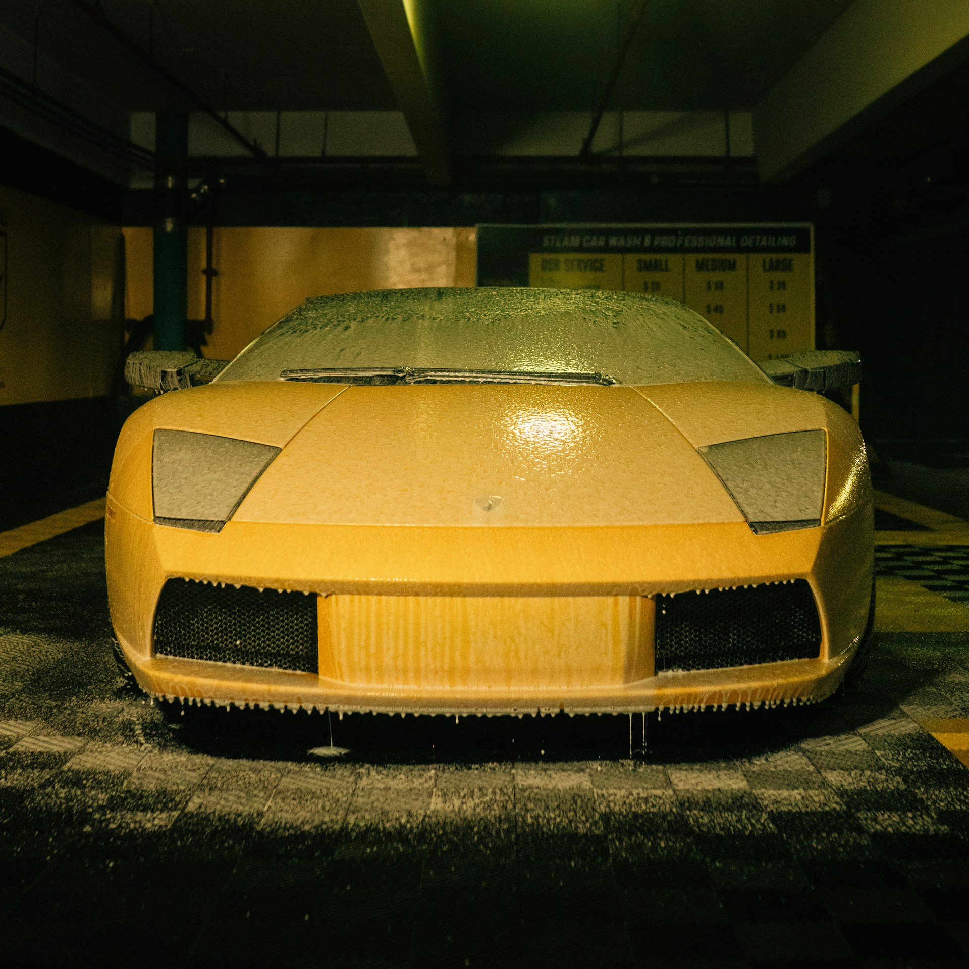 a yellow sports car parked in a parking garage