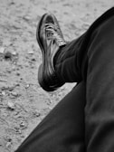 a black and white photo of a person's shoes