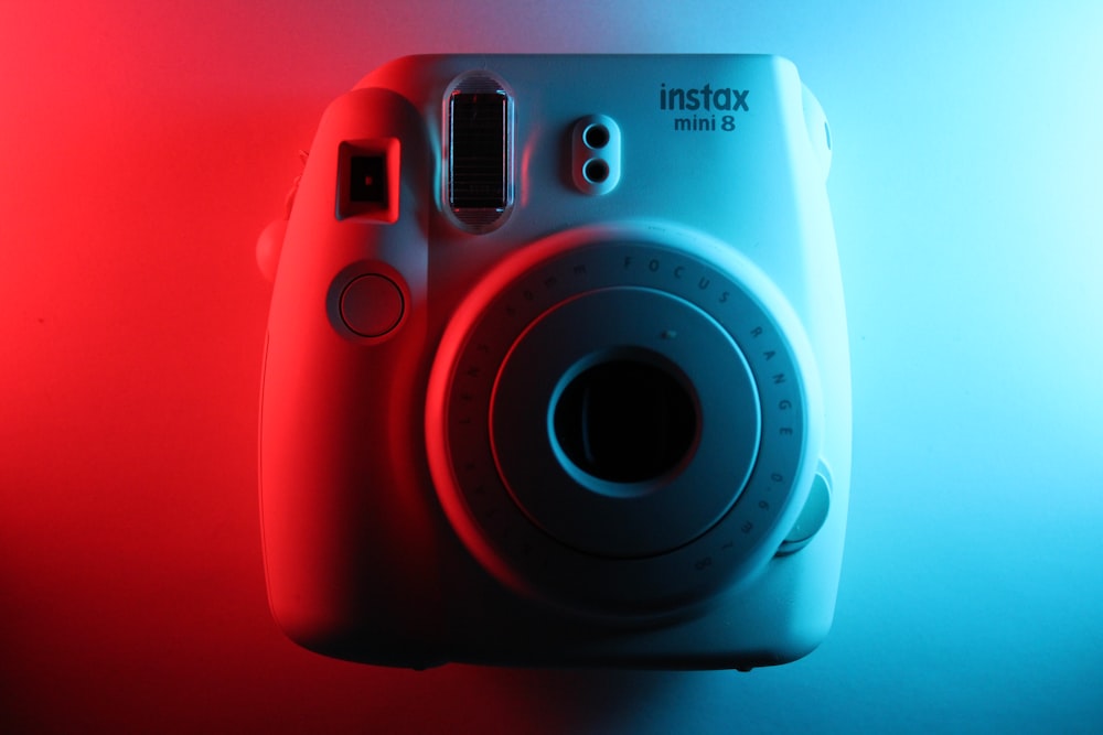 a close up of a camera on a red and blue background