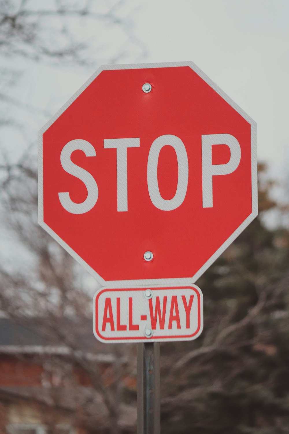 a red stop sign sitting on top of a metal pole