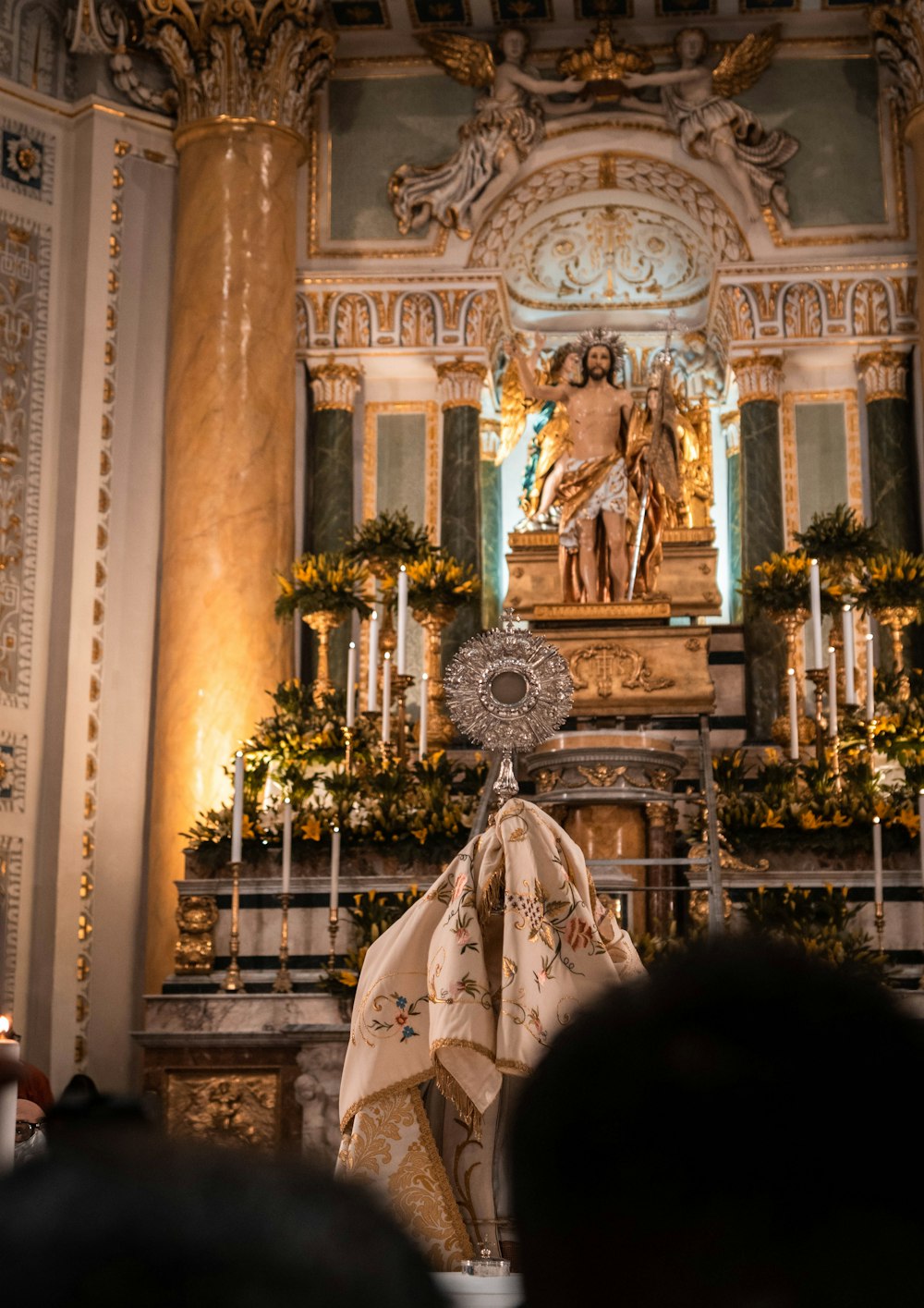 a church with a statue of a man holding a cross