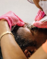 a man getting his hair cut by a hair stylist
