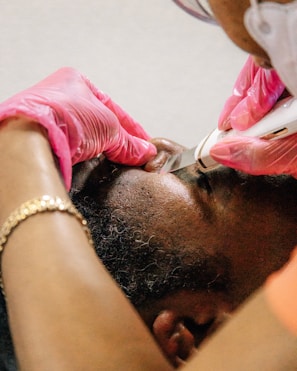 a man getting his hair cut by a hair stylist