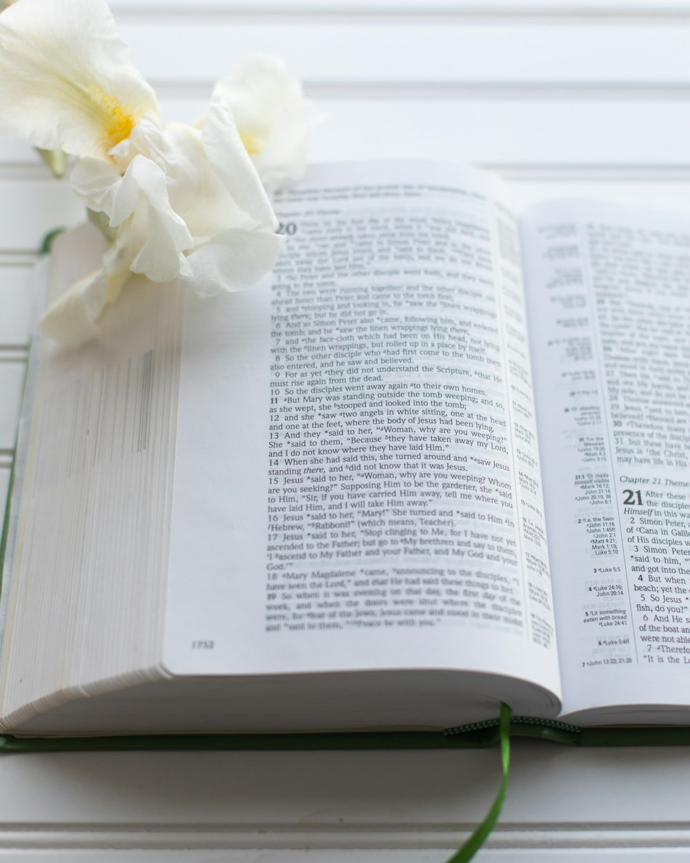 an open book with a flower on top of it