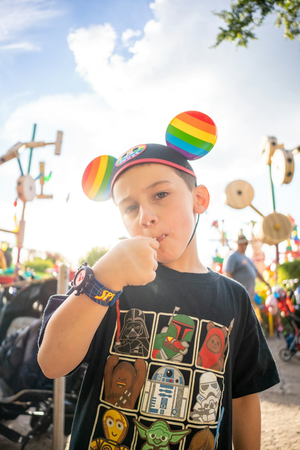 a young boy wearing a mickey mouse hat