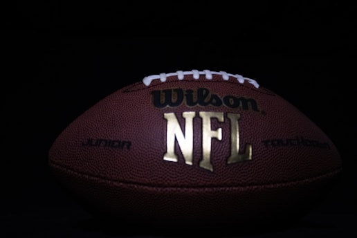 a close up of a football on a black background