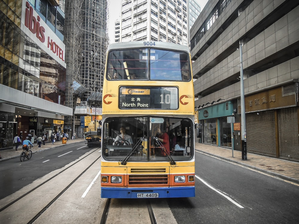 a double decker bus driving down a city street