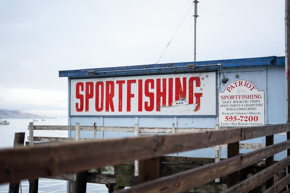 a sign on the side of a wooden pier
