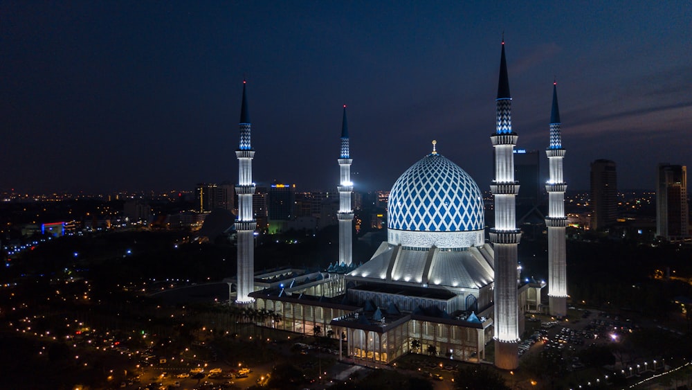 a night view of a large building with two towers