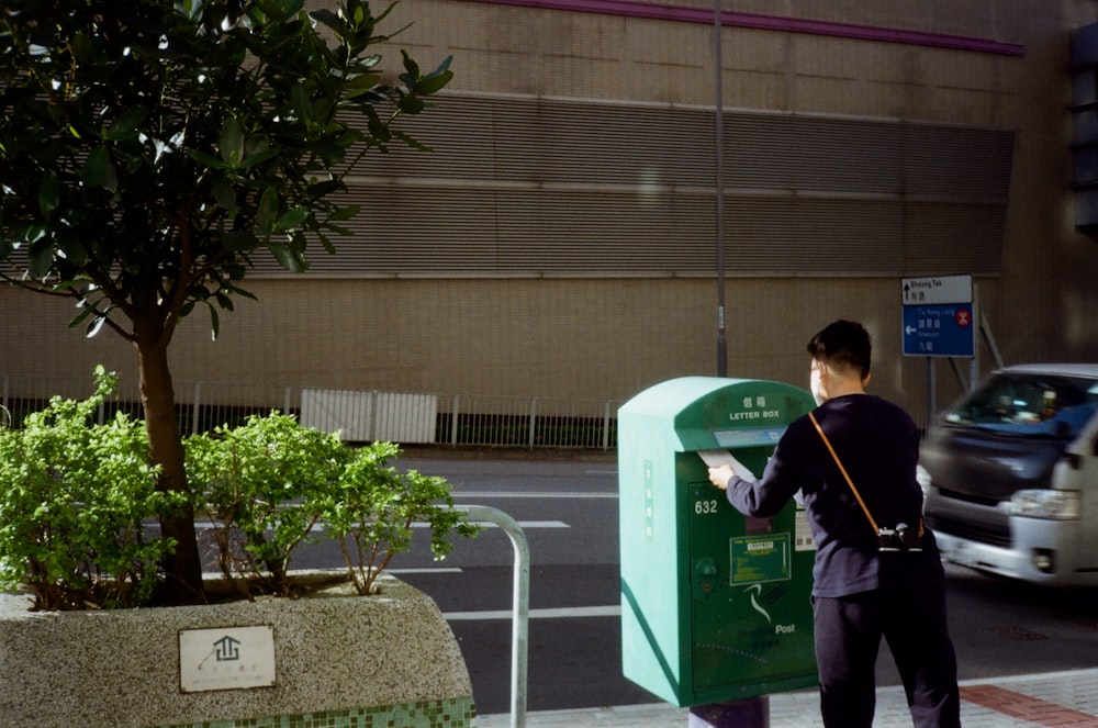 a man standing next to a parking meter